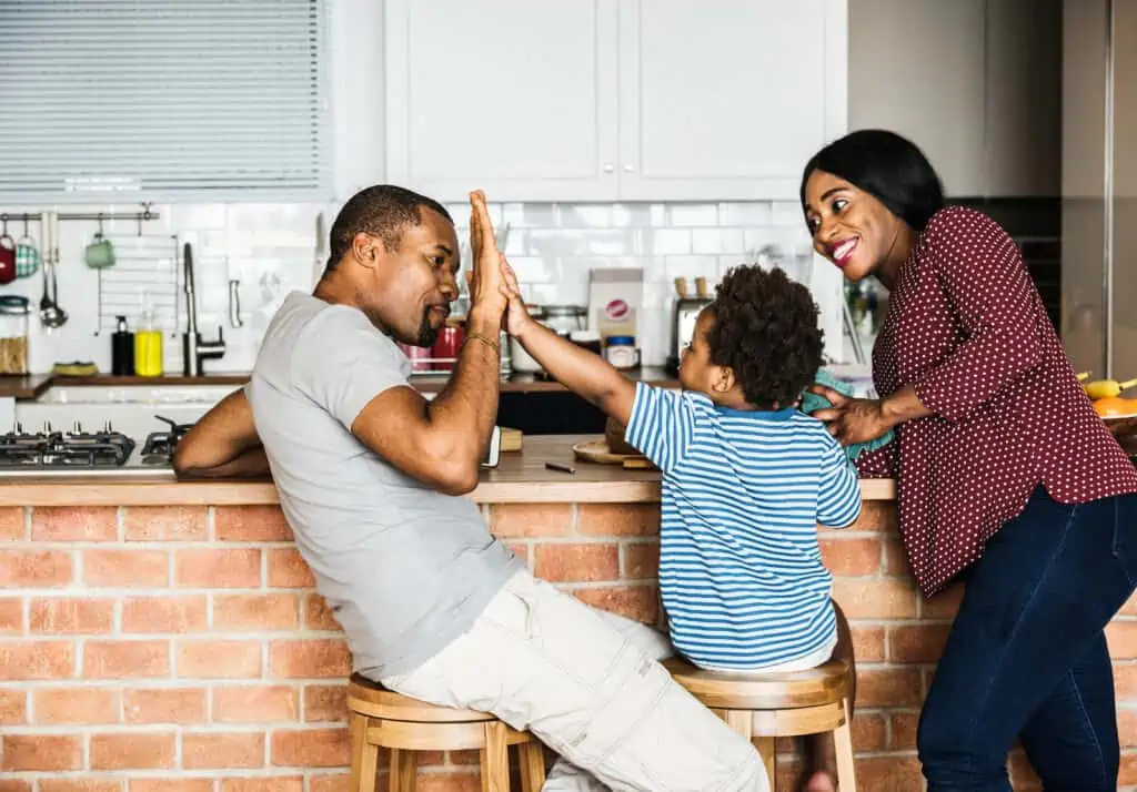 Examples of family traditions include celebrating milestones, like this family high-fiving each other